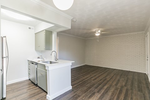 an empty kitchen and living room in an empty apartment