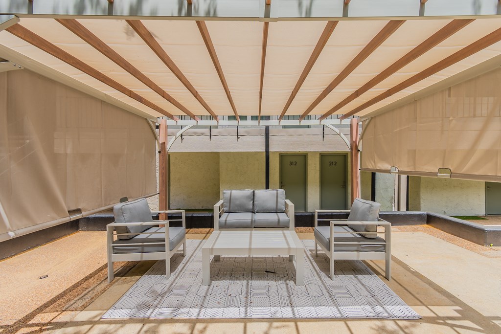 the lobby of a building with chairs and a canopy