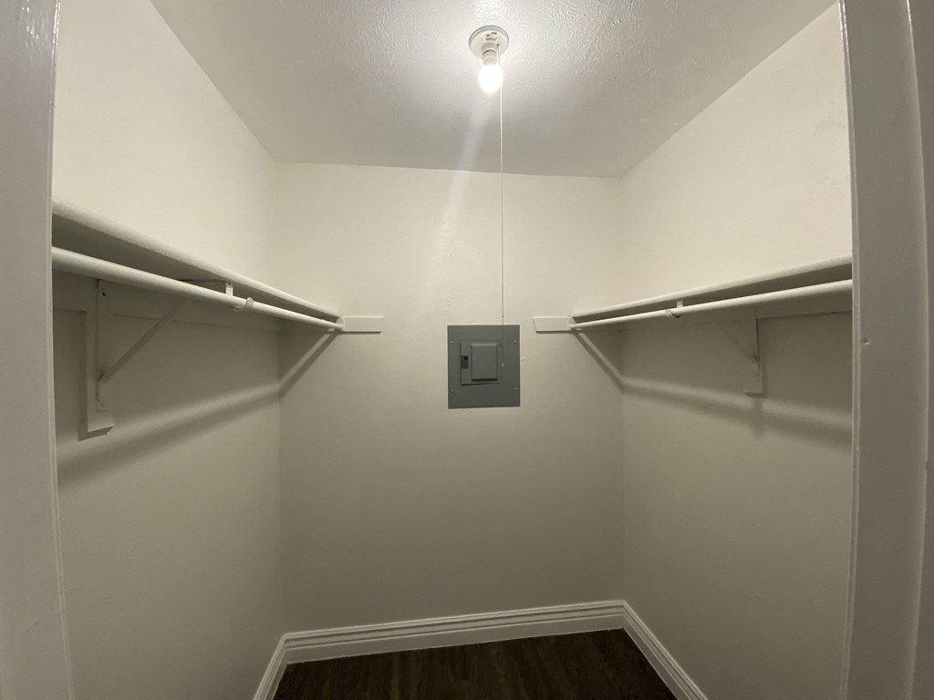 an empty room with two shelves and a light on the ceiling