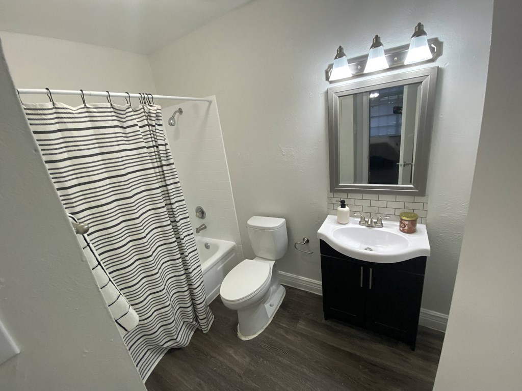 an empty bathroom with a shower toilet and sink