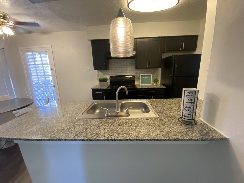 a kitchen with a sink and a counter top