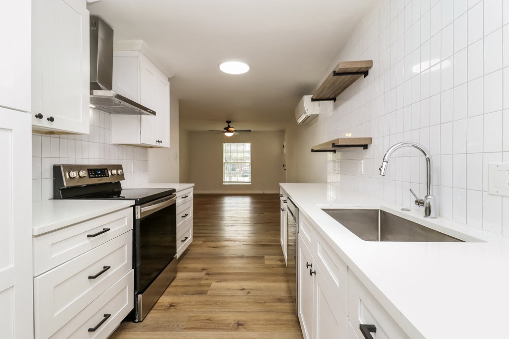 a kitchen with white cabinets and white countertops