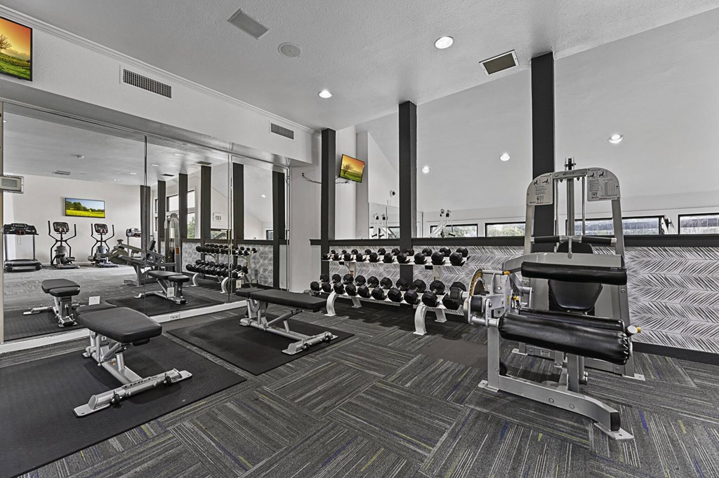 a gym with weights and cardio equipment at the estates at johnston crossing apartments at Lakeside Apartments, Dallas, TX, 75231