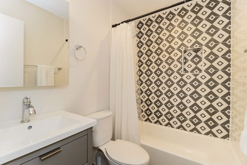 a bathroom with a sink and a toilet and a shower at The Eastern Apartments, Dallas, TX