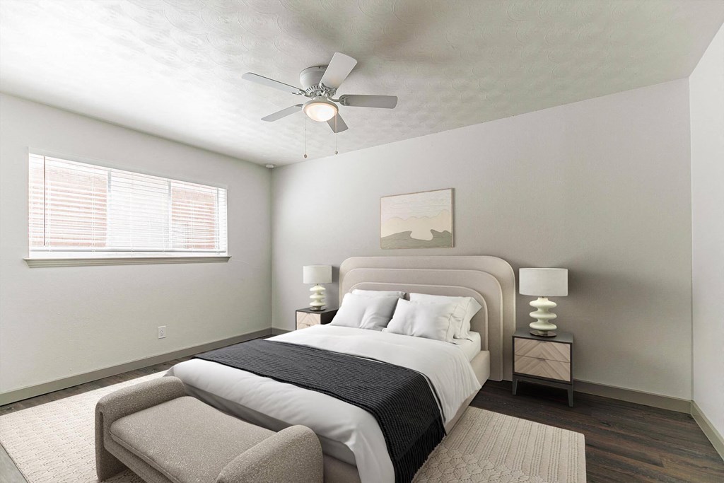 a bedroom with a large bed and a ceiling fan