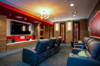Theater room with luxurious seating and large TV at Liberty Mill in Germantown, MD - Photo Gallery 7