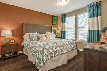 Bedroom with wood-designed flooring and window at Liberty Mill in Germantown, MD - Photo Gallery 21