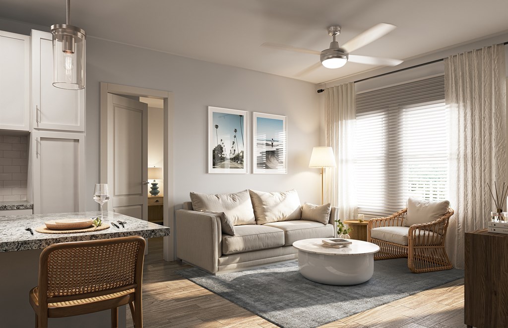 A modern living room with a dining area and a kitchen in the background.