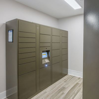 Package receiving room with lockers and a computer screen at Pelican Pointe Apartments in Slidell, LA