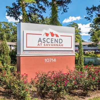 Large outdoor sign at the entrance of the property that says "Ascend at Savannah" with the web address and the accessibility symbol on the left and the fair housing logo on the right along with the address 10714