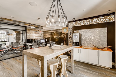 a kitchen with a dining table and a bar with stools