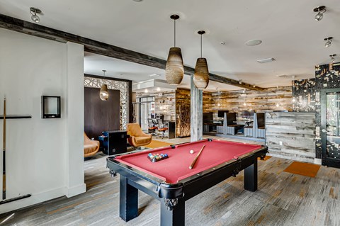 Resident clubhouse with pool table and gaming area at EOS in Orlando, FL