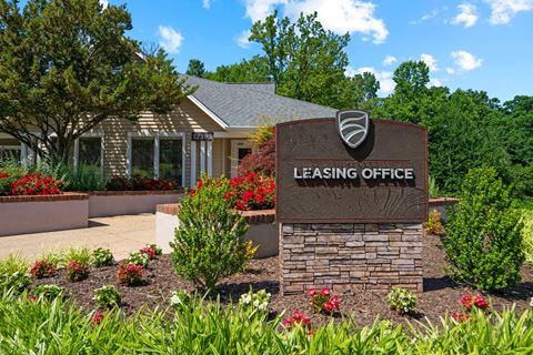 an image of the leasing office sign with a building in the background