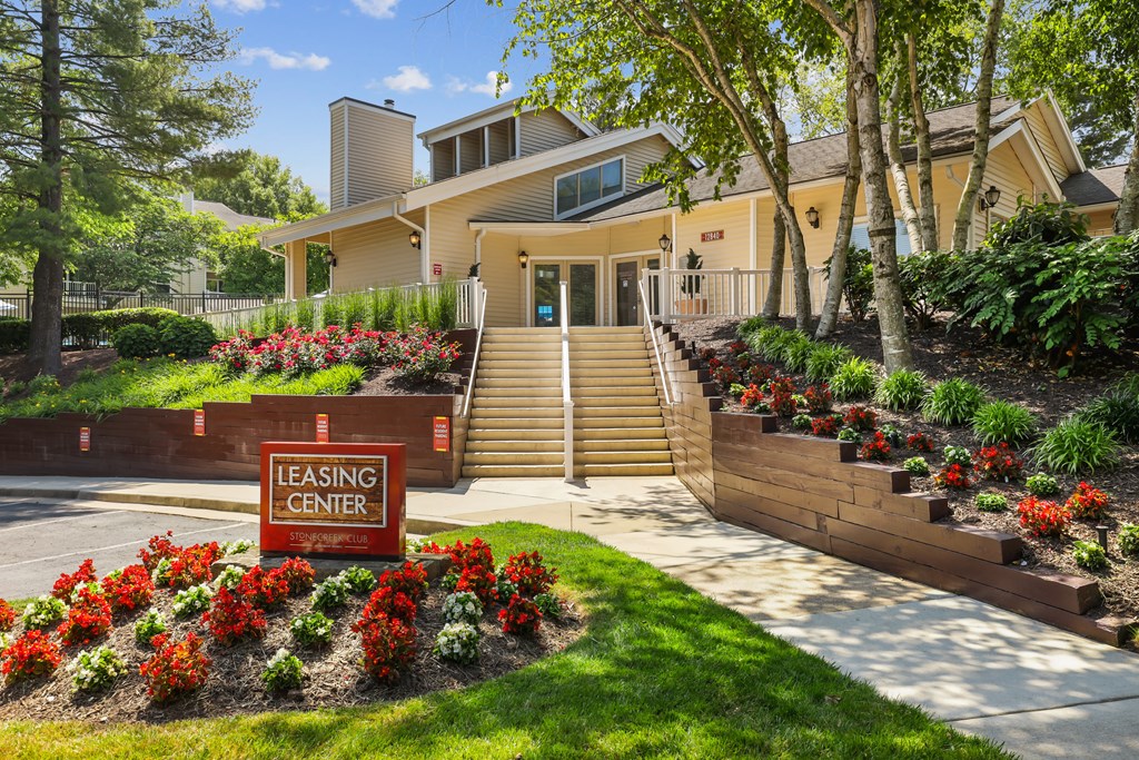 a building with stairs and a sign that reads leasing center