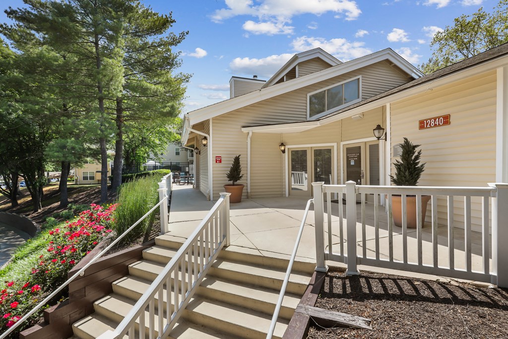 a view of the front of the building with stairs leading up to the door