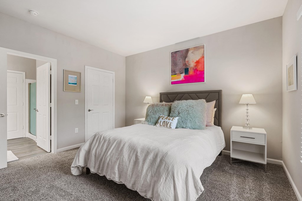 a bedroom with a bed and two night stands