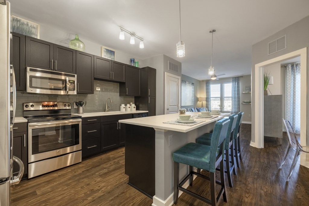 Kitchen with island and bar-style seating at Liberty Mill in Germantown, MD