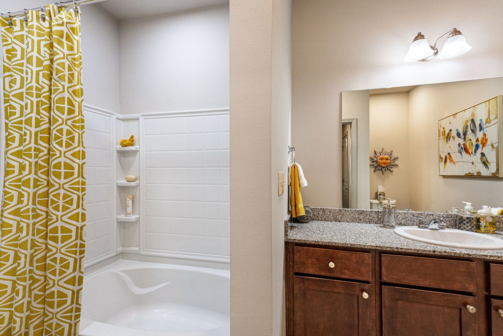 Bathroom with ceramic tub/shower and vanity at Reagan Crossing in Covington, LA