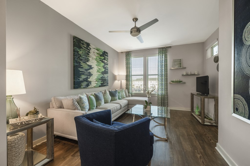 Living room with wood-designed flooring and ceiling fan at Liberty Mill in Germantown, MD