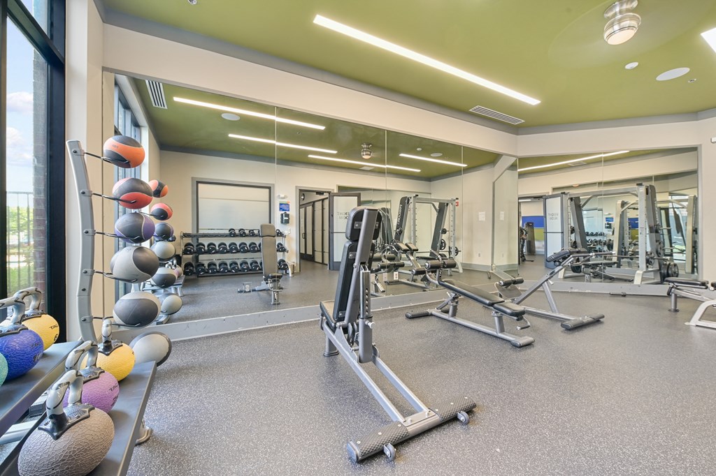 a spacious fitness center with weights and other exercise equipment