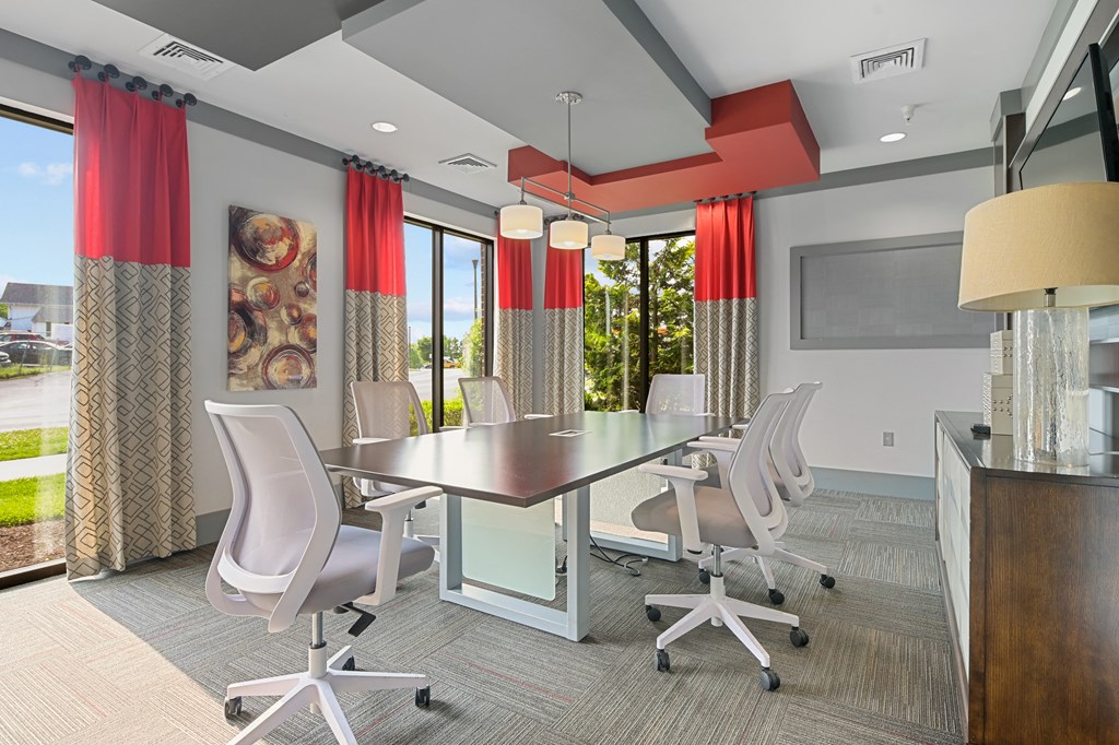 a conference room with a table and chairs