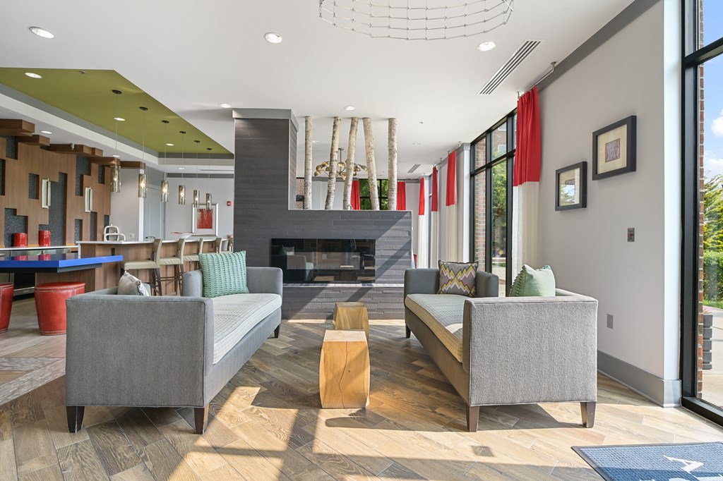 a living room filled with furniture and a large window