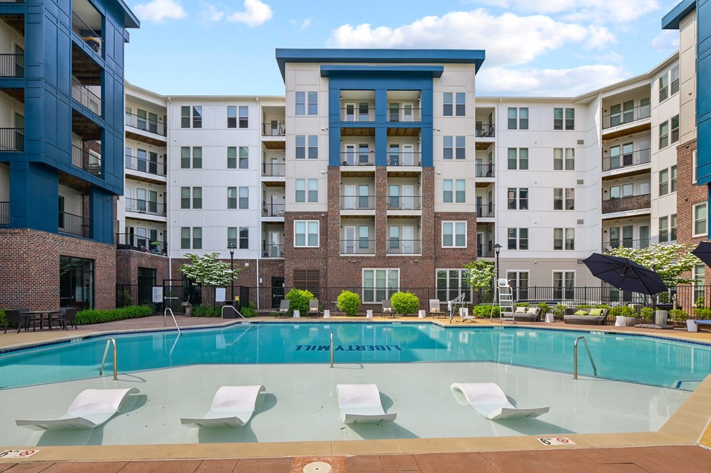 a swimming pool in front of an apartment building