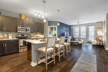 Open-concept floor plan with kitchen and island bar and living room at Liberty Mill in Germantown, MD - Photo Gallery 16