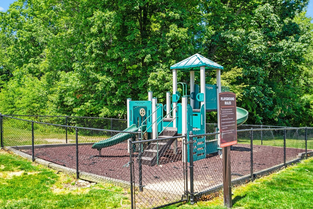 a playground in a park with trees in the background