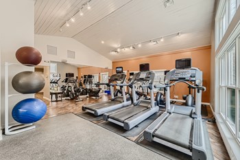 Premium fitness center with cardio and strength equipment at Hunt Club apartments for rent - Photo Gallery 21