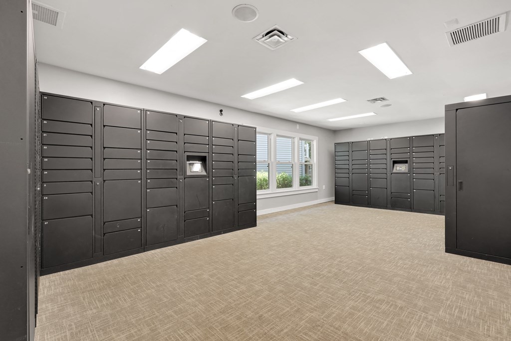 a large room with several rows of lockers and a window