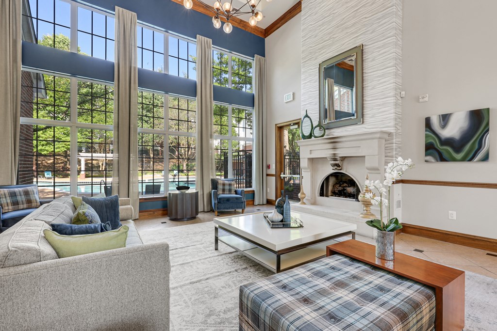 a large living room with a fireplace and large windows