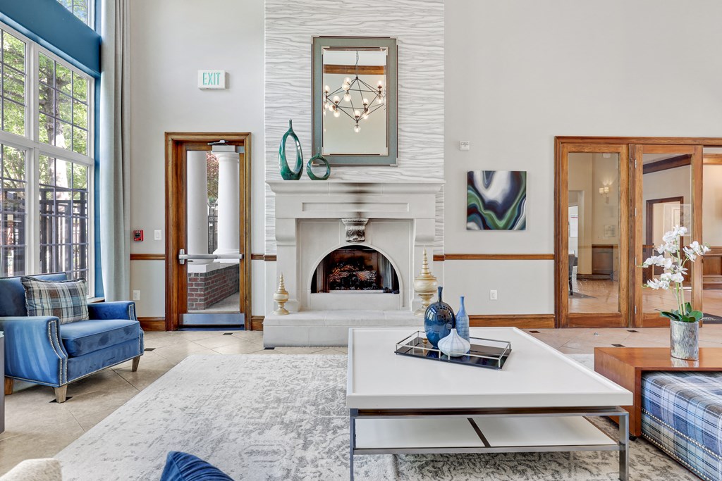 a living room with a white fireplace and blue furniture