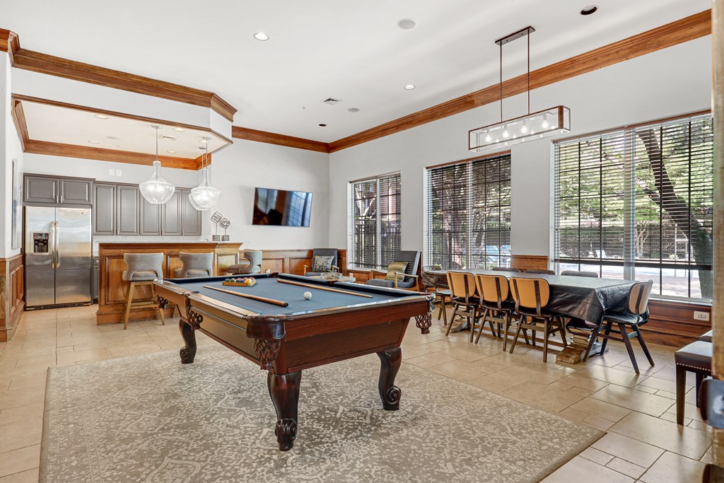 a game room with a pool table and a bar