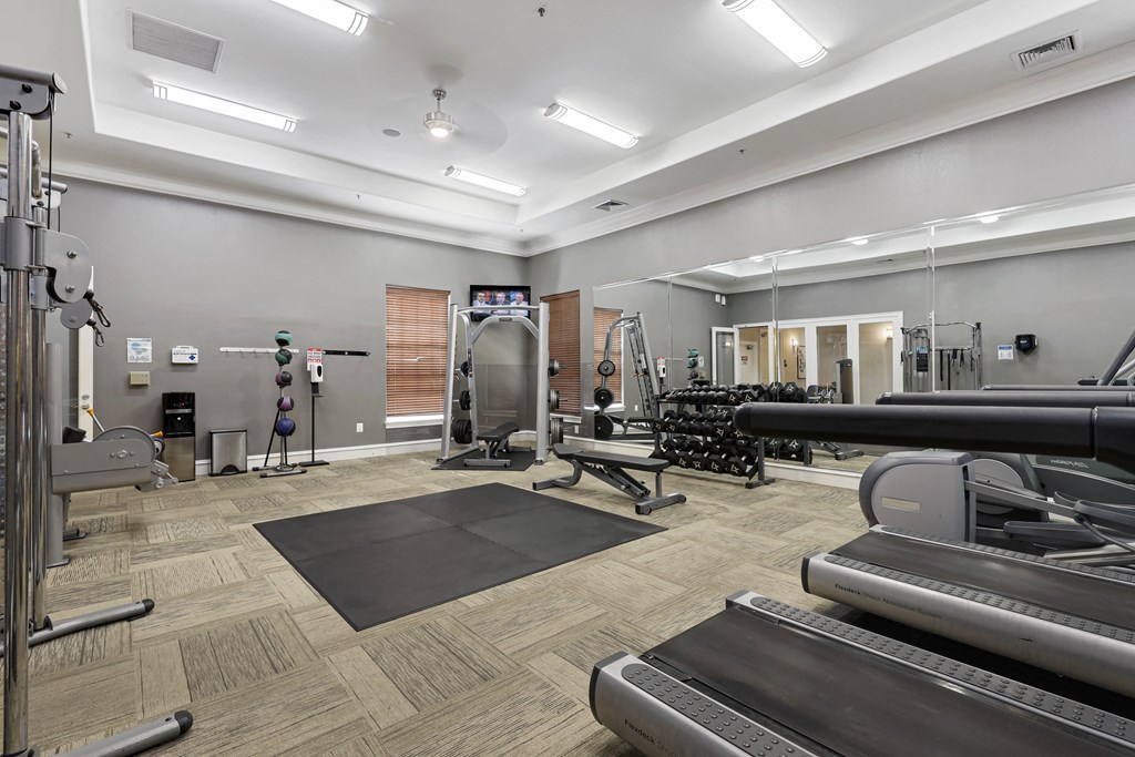a spacious fitness center with treadmills and other exercise equipment