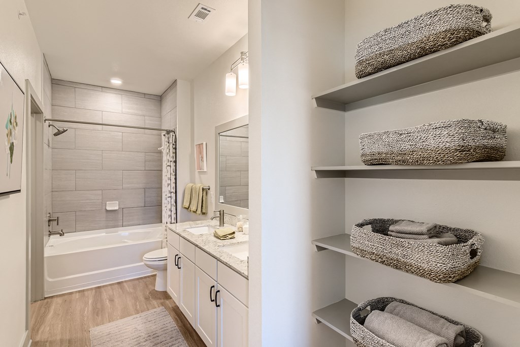 Bathroom with built-in storage and double-sink vanity at Cypress McKinney Falls in Austin, TX