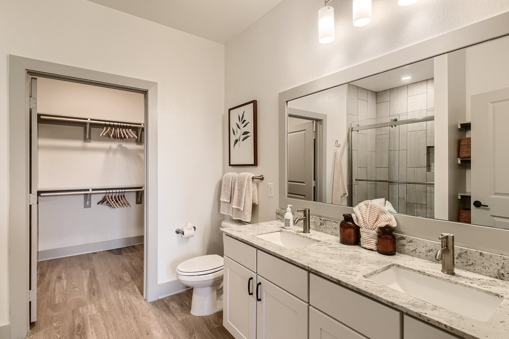Bathroom with double-sink vanity and walk-in shower at Cypress McKinney Falls in Austin, TX
