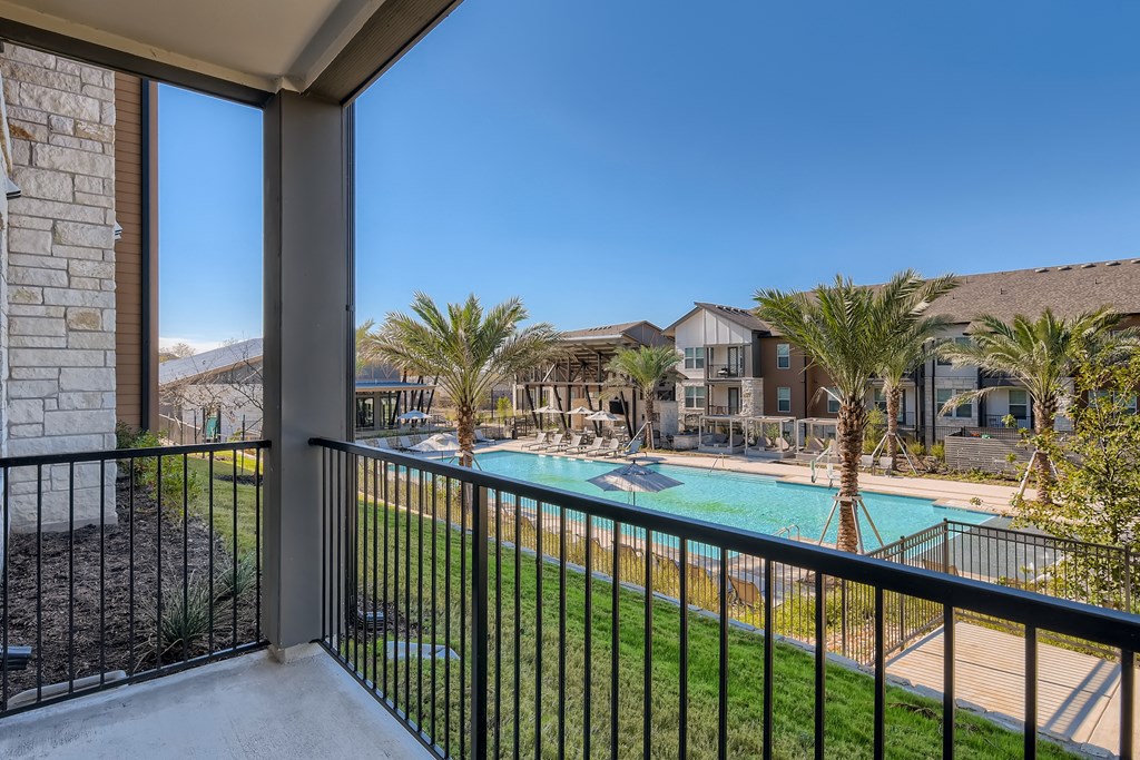 Private balcony overlooking the resort-style swimming pool at Cypress McKinney Falls in Austin, TX