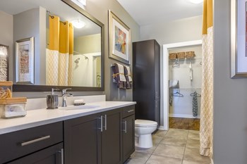 Bathroom with wide vanity and walk-in closet at Liberty Mill in Germantown, MD - Photo Gallery 20