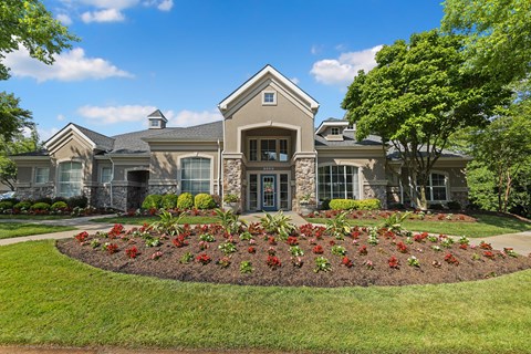 a home with a large flower bed in the front yard