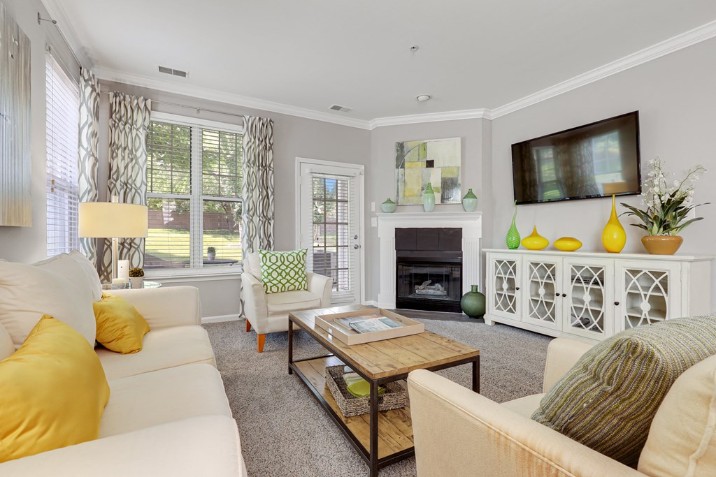 a living room filled with furniture and a flat screen tv