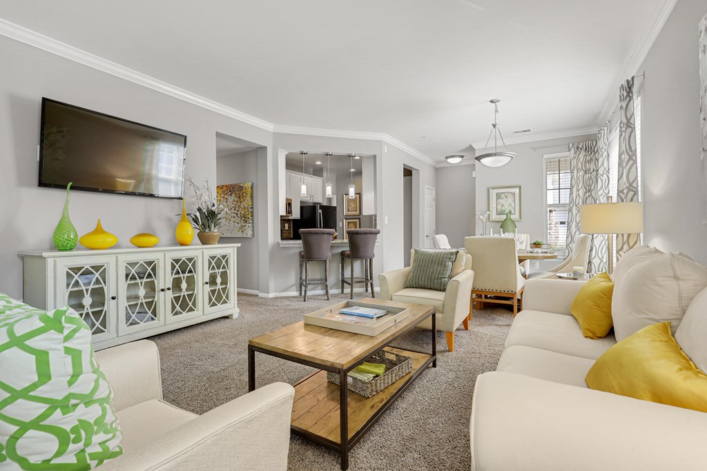 a living room filled with furniture and a flat screen tv