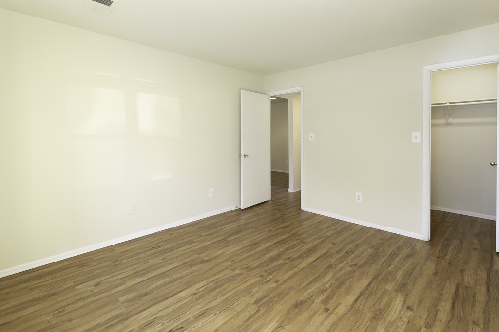 Bedroom with wood-designed flooring and closet at Windsor Park in Woodbridge, VA