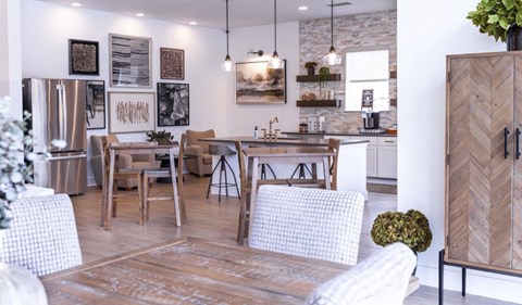 A modern kitchen with a dining table and chairs.