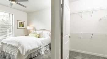 Comfortable bedroom and spacious closet at The Retreat at Fairhope Village in Fairhope, AL