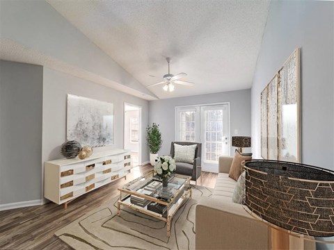 a living room with a couch and a ceiling fan