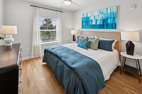 A bedroom with a large bed and a window with curtains. at Allegra at Cocoa in Cocoa, FL, 32926