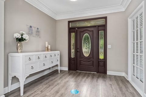 a foyer with hardwood floors and a wooden door