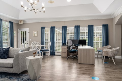 a living room filled with furniture and a chandelier