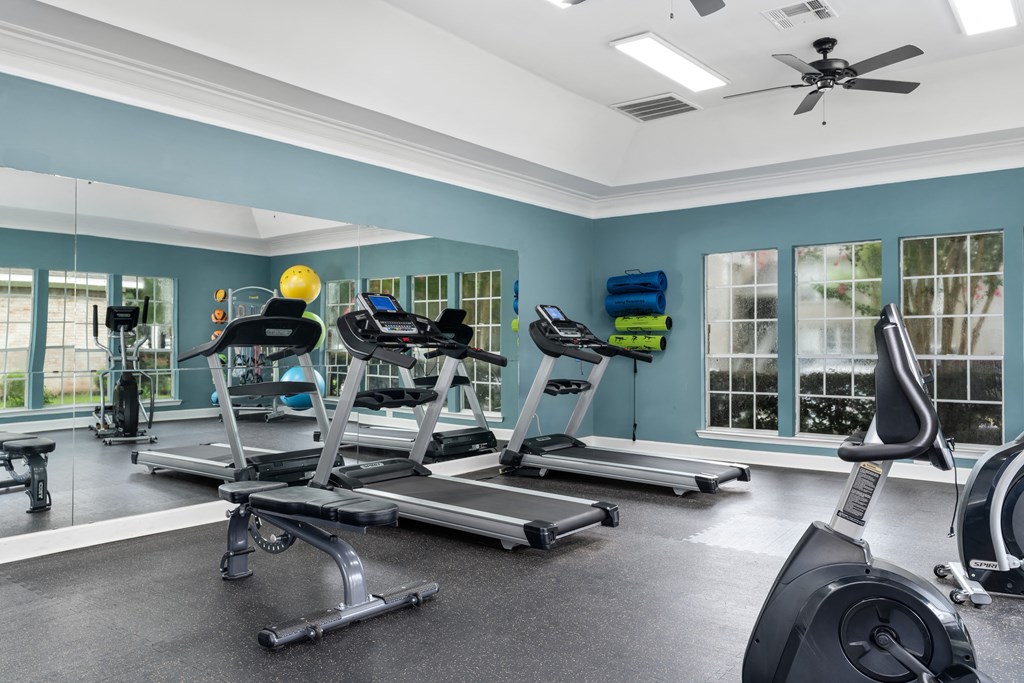 a home gym with treadmills and exercise bikes
